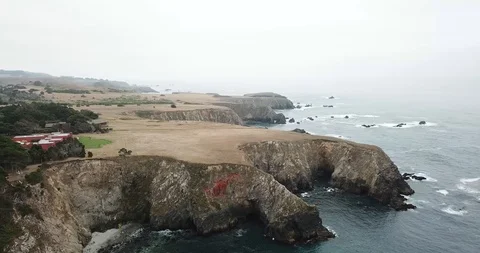 Pan from house on cliff to ocean Stock Footage 94462769