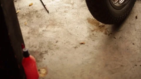 Pan of instruments lying on mechanics shop floor Stock Footage 72713491
