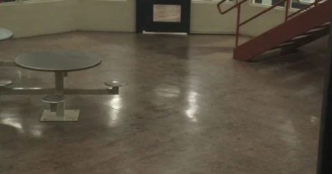 Pan of Interior of Jail Pod - Empty Tables Stock Footage 82969865