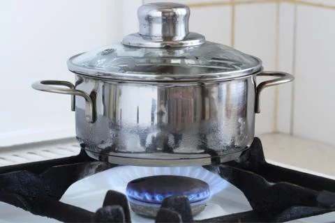 Pan on kitchen stove Stock Photos