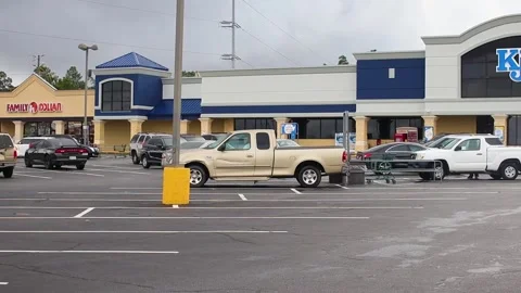 Pan of KJ's grocery store parking lot and building Stock Footage 142974058
