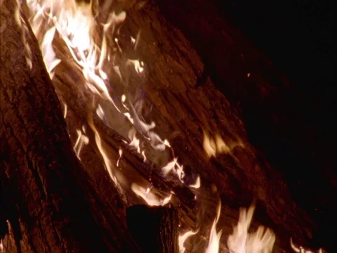 Pan L to R across MS flames on ground at night. Stock Footage 86751013