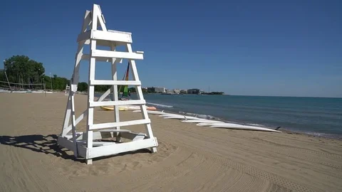 PAN L-R FROM LIFE GUARD CHARI TO LIFEGUARD BOAT Stock Footage 78506094