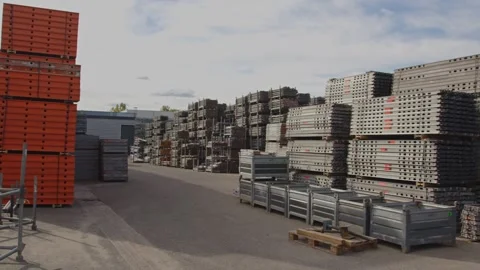 Pan of a large industrial storage yard filled with stacks of material and Vídeo Stock 318349039