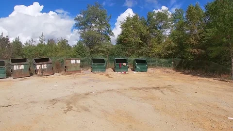 Pan of a large rural dump with open top dumpsters Stock Footage 144227367