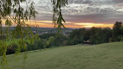 Pan from Leaves in Foreground to Recreation Area with Sail Roof in 4K Video stock 317583353