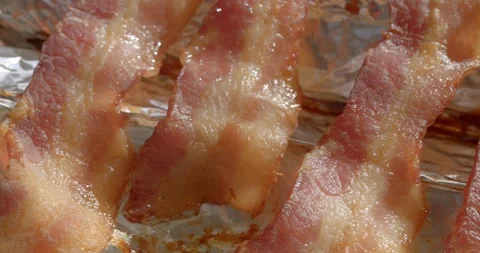 Pan left across cooked bacon, macro close-up 4K Stock Footage 126944795