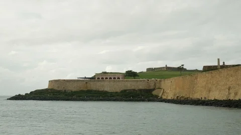 Pan left across Paseo del Morro oceanfront stone seawall bay walk Stock Footage 96257341