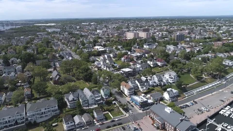 Pan Left And Down Over City Parking Lot And Water 库存影片 91896738