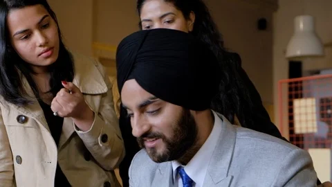 Pan left and right closeups of boss with his incompetent team as he is laughing  Stock Footage 101890602