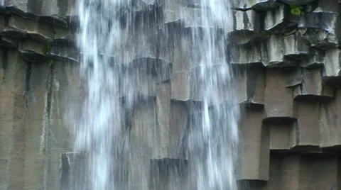 Pan left on basalt to reveal waterfall Stock Footage 38020464