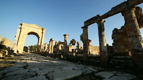 Pan left between The Roman Triumphal Arch and Hippodrome, Tyre, Lebanon Stock Footage 119099048