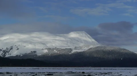 Pan Left Broken Ice River, Distant Snowy Mountain Range Stock Footage 38053465