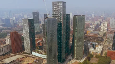 Pan left by Buildings Great Jackson Street Deansgate Manchester Видео 341987392