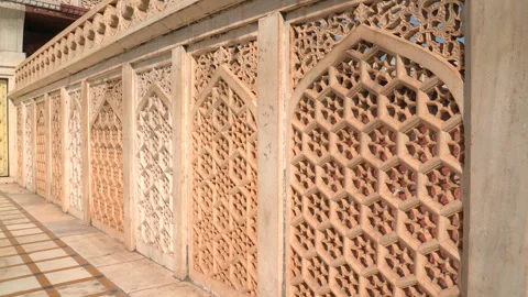 Pan left of carved stone jali lattice screen at Agra Fort in India Stock Footage 343883856