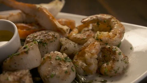 Pan left of crab being dipped in butter  動画素材 112660468