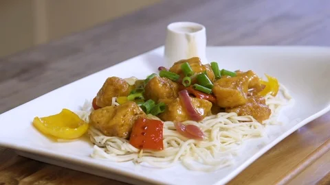 Pan left on a dish of chicken fillet, vegetables, and noodles Stock Footage 122763751