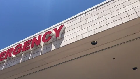 Pan Left To Emergency Sign At Hospital  IMG 9737 Stock Footage
