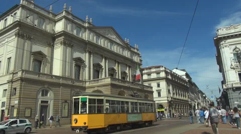 Pan left fallow yellow old tram Milan downtown iconic view traffic car street  Stock Footage 43964128