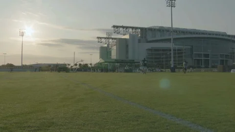 Pan left flood lights and stadium building seen from field Stock Footage 104767958
