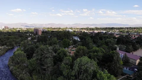Pan left flying over truckee river and residential with downtown reno NV cas Stock Footage 123096494