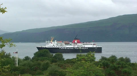 Pan left following ferry sailing on loch Stock Footage 39815876