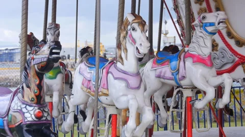 Pan left to merry-go-round horses in public park. Stock Footage 62860619