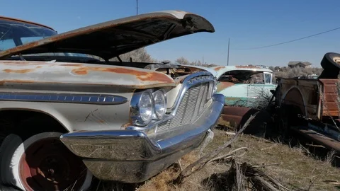 Pan Left Old Car In Junk Yard Video stock 106415242