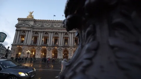 Pan left reveals the Old Garnier Opera House in Paris, between tourists and Stock Footage 93415826