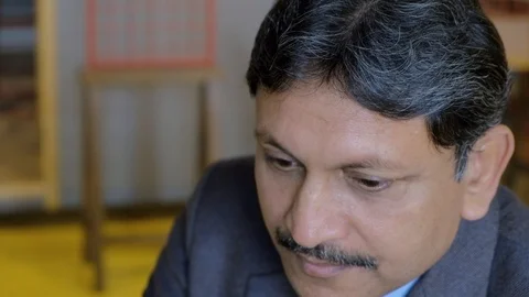 Pan left to right closeups between two business men working on a touch screen ta Stock Footage 102548058