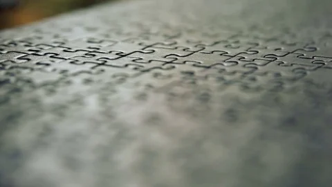 Pan from left to right of complete puzzle, shallow depth of field Stock Footage 73441377