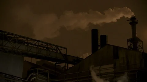 Pan left to right of factory, smoke and gas stacks at night Stock Footage 89945443