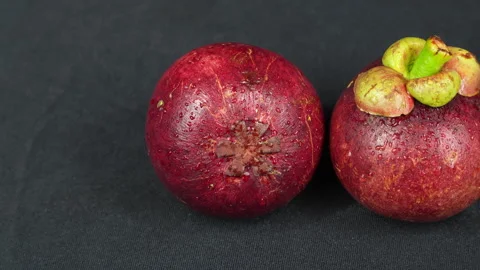 Pan Left To Right Fresh Wet Mangosteens On Black Background Stock Footage 336228680