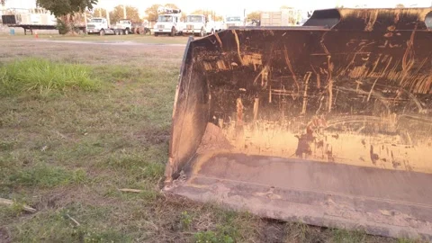Pan left to right Front view of yellow scraped marked wheel loader, scraper and Stock Footage 263901877