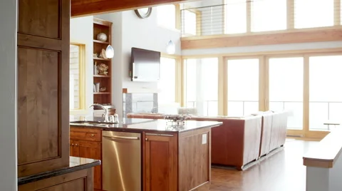 Pan left to right of a large living room and kitchen in a modern house Stock Footage 43670845