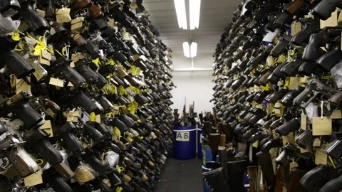 Pan left to right - Police's seized weapons storage room Video stock 87925038