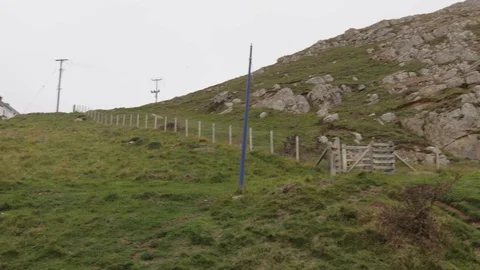 Pan from left to right of a rocky hillside with trees Stock Footage 98745570