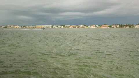 Pan left to right speed boat view across Bay water towards Vina Del Mar Island o Stock Footage 283682222