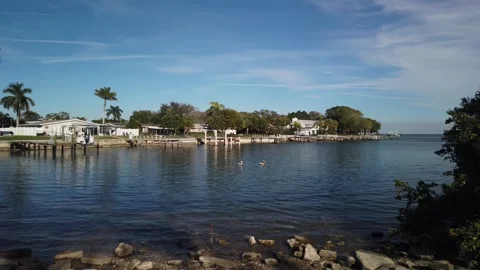 Pan left to right View from Bay Vista Park boat cove over green grass, Boat dock Stock Footage 265716304
