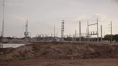 Pan left to right Wide view near sunset of Electric Substation with High Power L Stock Footage 281992395