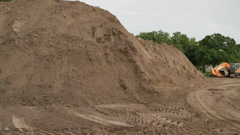 Pan left to right Wide view  dirt pile on left to construction equipment Electri Stock Footage 281992396