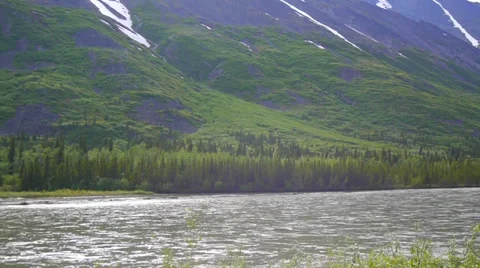 Pan Left  River Flows Through Grassy Mountain Valley 2 Stock Footage 37436644