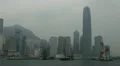 Pan Left Shot of Hong Kong Skyline with Skyscrapers and Boats in Monsoon Season HD Footage