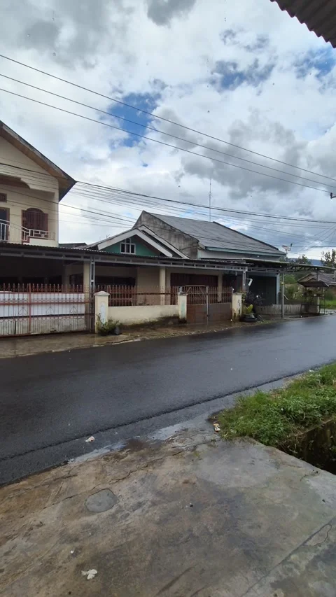 Pan left shot of a quiet suburban street after rain Stock Footage 335136332