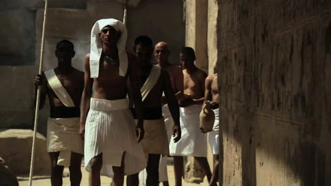 Pan left shot of recreation: Pharaoh (Amenhotep IV or Akhenaten) walking through Stock Footage 202909305
