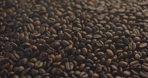 Pan to left shot of roasted coffee beans with smoke slow motion Stock Footage 129382788