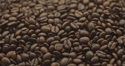 Pan to left shot of roasted coffee beans slow motion Stock Footage 129382805