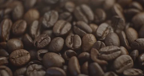Pan to left shot of roasted coffee beans slow motion close up Stock Footage 129382815