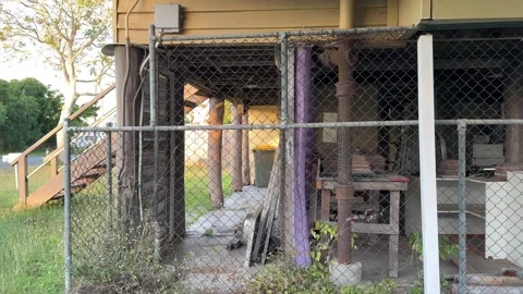 Pan Left Shot of the Underneath of a High-Set Queenslander House Stock Footage 339166846