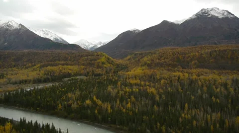Pan Left Snow-capped Mountains, Fall Trees and River Foreground Stock Footage 38092067